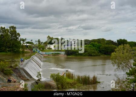 People fishing and mucking around on the weir near Riverview Tavern in Douglas Townsville Queensland Australia Stock Photo