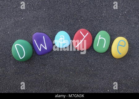 Dwayne, masculine given name with multicolored stones over black volcanic sand Stock Photo