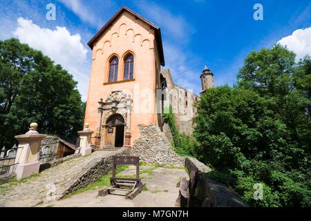 Pillory and Renaissance entrance portal to Grodno castle in Zagorze Slaskie, Lower Silesia, Poland. Tables with Polish description of the portal on th Stock Photo
