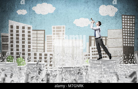 Businessman playing fife while standing among flying letters with drawn cityscape on background. Mixed media. Stock Photo