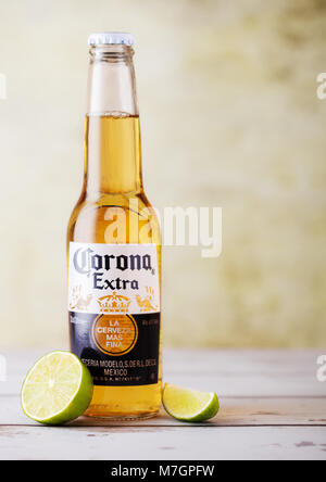 LONDON, UK - MARCH 10, 2018 : Bottles of Corona Extra Beer with lime slice on wooden background.Corona is the most popular imported beer in the US. Stock Photo