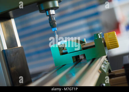 Processing of the plastic workpiece on CNC milling machine Stock Photo