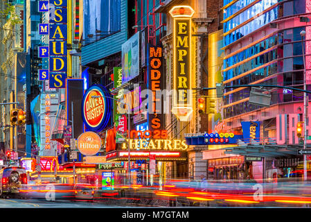 NEW YORK CITY - NOVEMBER 14, 2016: Traffic moves below the illuminated signs of 42nd Street. The landmark street is home to numerous theaters, stores, Stock Photo