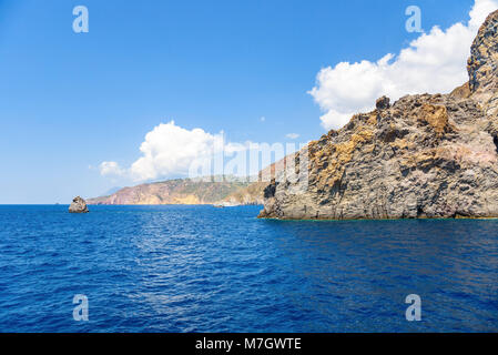 Rocky cliff coast of the Lipari Island seen from the sea, Aeolian Islands, Italy Stock Photo
