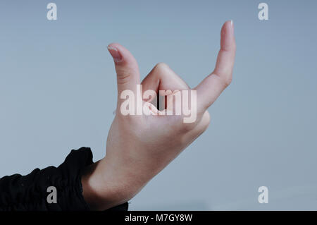 Female Hand Holding Isolated Card with Two Fingers Close Up Stock Photo