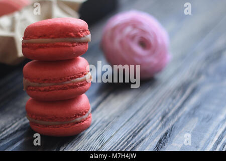 Colorful macaroons and flowers on table Stock Photo