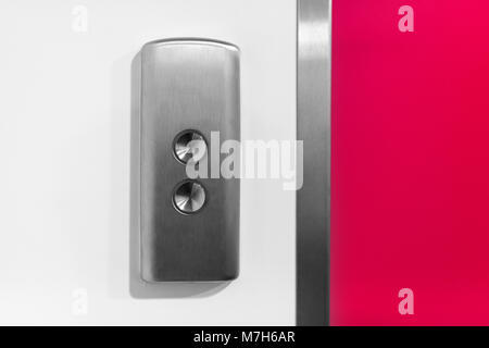 Metal elevator Button on the white wall Stock Photo