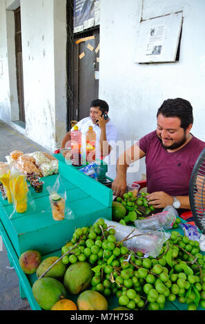 Mexican local men at fruits stand, Izamal, Yucatan, Mexico Stock Photo