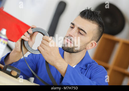 auto mobile mechanic with a piece to changer Stock Photo