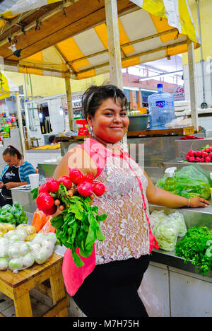 Mexican woman selling vegetables at a stand of local market, Merida, Yucatan, Mexico Stock Photo