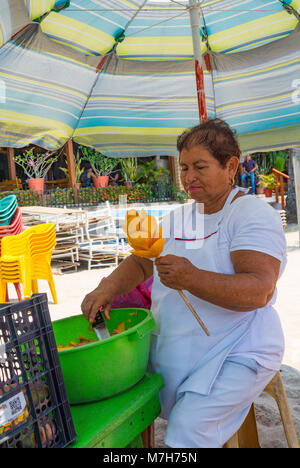 Puerto Vallarta, Jalisco, A senior mexican woman preparing a mango. Editorial only. Stock Photo