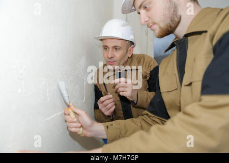 two builders making finish in the apartment Stock Photo