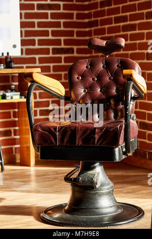 Barber shop, hairdresser chairs made from brown leather. Retro leather chair barber shop in vintage style. Vintage equipment. Male beauty and care. Gr Stock Photo