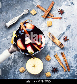 pot with red mulled wine with apple and spices Stock Photo