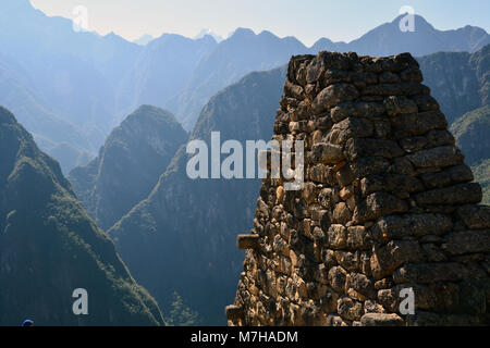 Part of the ruins of Machu Picchu is silhouetted against the Andes Mountains in Peru.
