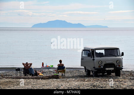 People bathering and resting on the beach of Ola, a city east of Magadan, Kolyma. Stock Photo