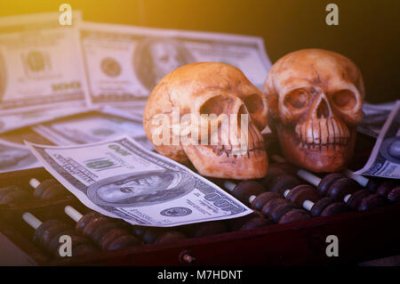 skull on bank note and coin, money, concept in work for money and death because of money Stock Photo