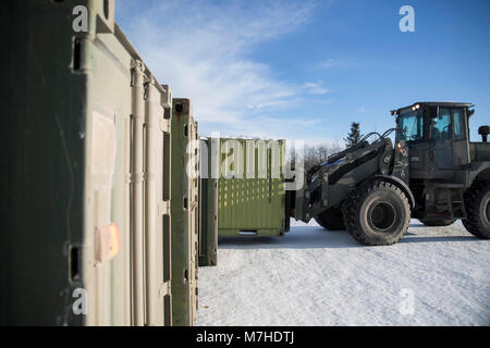 A Marine with Combat Logistics Regiment 25 moves a quadcon full of gear at Fort Greely, Alaska in preparation for Exercise Arctic Edge 18, March 10, 2018. Arctic Edge 18 is a biennial, large-scale, joint-training exercise that prepares and tests the U.S. military’s ability to operate tactically in the extreme cold-weather conditions found in Arctic environments with more than 1500 participants from the Air Force, Army, Coast Guard, Marine Corps, and Navy utilizing the unique and expansive air and ground training areas in Alaska. (U.S Marine Corps photo by Sgt. Brianna Gaudi) Stock Photo