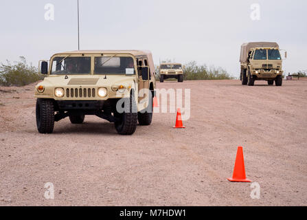 Arizona Army National Guard Soldiers from the 198th Regional Support Group, Headquarters and Headquarters Company weave a M1097 Humvee through cones during driver’s training March 10, 2018, at Papago Park Military Reservation in Phoenix, Ariz. After spending time in the classroom learning about the tactical vehicles, Soldiers completed a driving course which qualified them to be licensed on the vehicles. (Arizona Army National Guard photo by Staff Sgt. Brian A. Barbour) Stock Photo