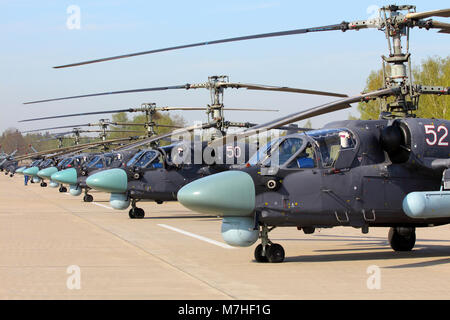 Row of Ka-52 Alligator attack helicopters of the Russian Air Force. Stock Photo