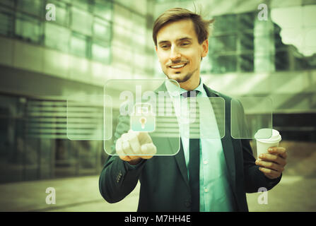 Man in business suit pressing icons on virtual digital touchscreen Stock Photo