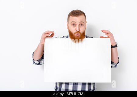 handsome man with beard holding big white card. empty blank board Stock Photo