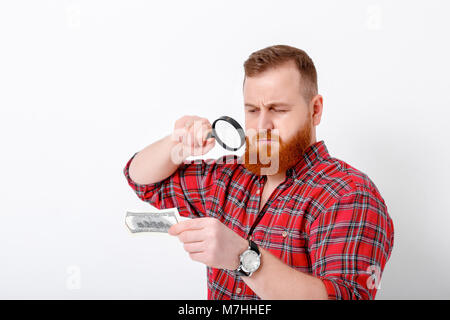 man looking at magnifying glass for bill Stock Photo