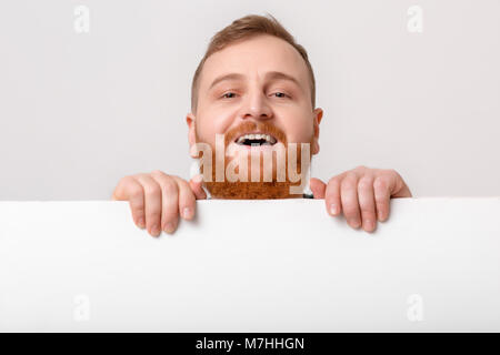 man with beard holding big white card. Stock Photo