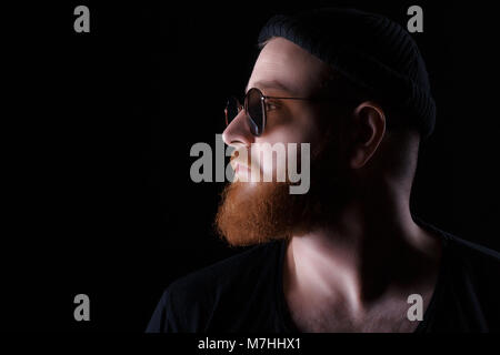 bearded man in sunglasses and hat Stock Photo