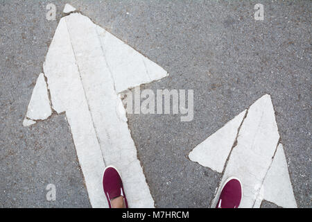 Shoes standing at the crossroad and get to decision which way to go. Two ways to choose concept. Stock Photo