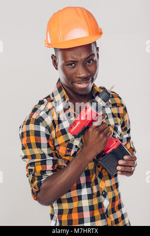 African American worker uses electric screwdriver Stock Photo