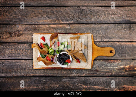 Chicken pate with plum sauce, served with croutons. Top view Stock Photo