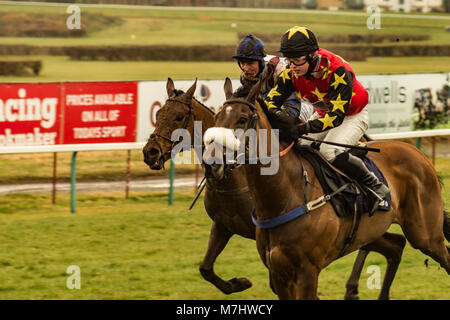 Hereford, Herefordshire, UK. 10th March, 2018. Colt Lightning leads Sackett in the 1:40pm race at Hereford racecourse during Ladies Day in Hereford on 10th March 2018. Credit: Jim Wood/Alamy Live News Stock Photo