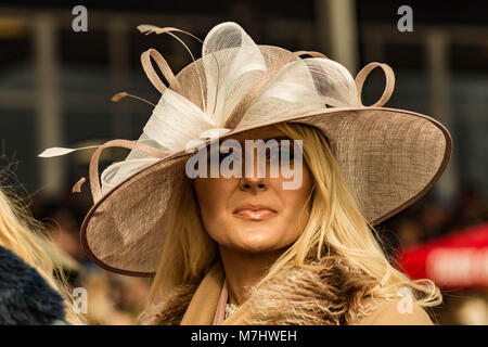 Hereford, Herefordshire, UK. 10th March, 2018. A woman wears a wide brimmed hat at Hereford racecourse during Ladies Day in Hereford on 10th March 2018. Credit: Jim Wood/Alamy Live News Stock Photo