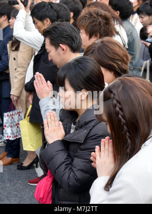 Tokyo, Japan. 11th Mar, 2018. Tens of thousands of people offer silent prayers for those perished in the massive earthquake and tsunami at Tokyos bustling Ginza shopping district on Sunday, March 11, 2018, as Japan observes the seventh anniversary of the nations worst ever disaster in 2011. More than 73,000 people have yet to returned to their hometowns in the aftermath of the calamity that wreaked havoc on a wide swath of Japans northeastern region seven years ago today. Credit: Natsuki Sakai/AFLO/Alamy Live News Stock Photo