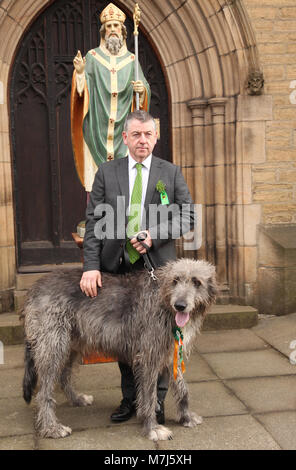 Manchester, UK 11 March 2018. Manchester Irish Festival March 2018.  The parade commenced at the Irish World Heritage Centre, In Cheetham Hill, Manchester and finished outside the town hall.  John Flanagan is pictured outside a statue of St. Patrick @ St. Chads Church Credit: Gerard Noonan/Alamy Live News Stock Photo