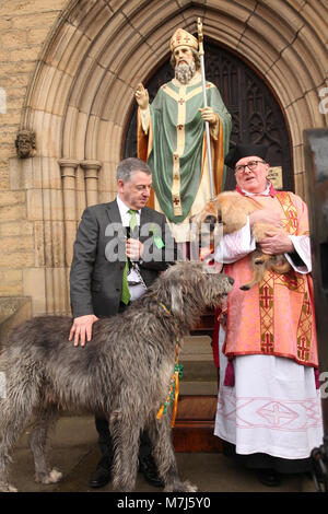 Manchester, UK 11 March 2018. Manchester Irish Festival March 2018.  The parade commenced at the Irish World Heritage Centre, In Cheetham Hill, Manchester and finished outside the town hall. John Flanagan is pictured outside a statue of St. Patrick @ St. Chads Church with Fr Ray Matus Credit: Gerard Noonan/Alamy Live News Stock Photo