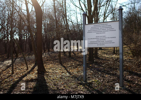 Krakow, Poland, Poland. 11th March, 2018. A plaque informing passers-by about entering the area of former concentration camp Krakow-Plaszow. Credit: Filip Radwanski/Alamy Live News Stock Photo