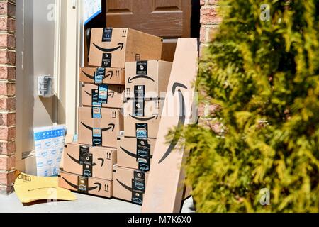 Amazon Prime boxes delivered and stacked at the front door of a ...