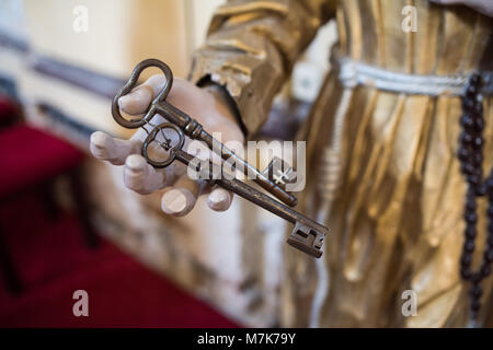 Old ancient bronze keys in monk hand Stock Photo