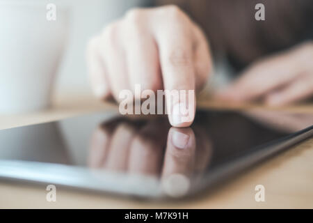 Closeup image of a woman's hand pointing , touching and using tablet pc Stock Photo