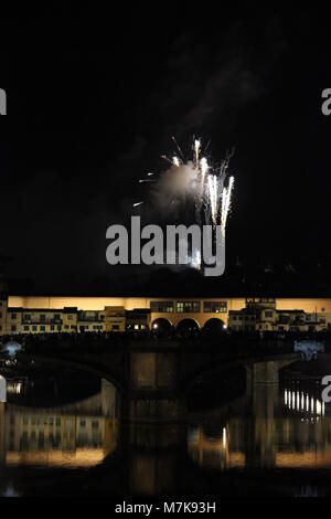 FLORENCE, ITALY - JUNE 24 2013: Fireworks by the historic Ponte Vecchio bridge in Florence, for the patron saint day Stock Photo