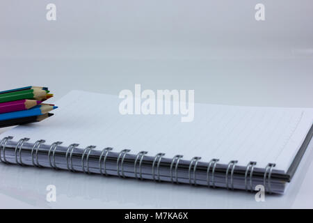 blank notebook isolated on white background with color pencil Stock Photo