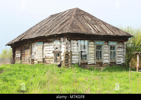 Abandoned wooden house with boarded up windows in the Russian countryside. Stock Photo