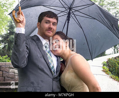 Bride and groom on a rainy wedding day. Stock Photo