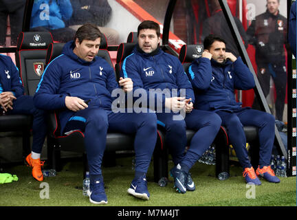 Tottenham Hotspur manager Mauricio Pochettino (centre) with First Team Coach Miguel D'Agostino (left) and Assistant Manager Jesus Perez during the Premier League match at the Vitality Stadium, Bournemouth. Stock Photo