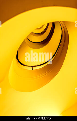 Yellow spiral staircase in a hotel; gelbe Wendeltreppe in einem Hotel Stock Photo