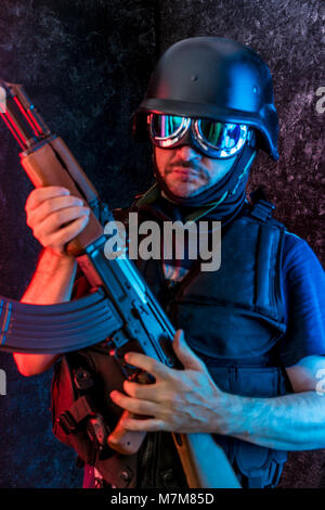 Thief, man armed with shotgun and bulletproof vest Stock Photo