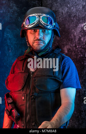 Thief, man armed with shotgun and bulletproof vest Stock Photo