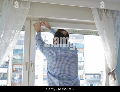 Man marking position for installing a new blind Stock Photo